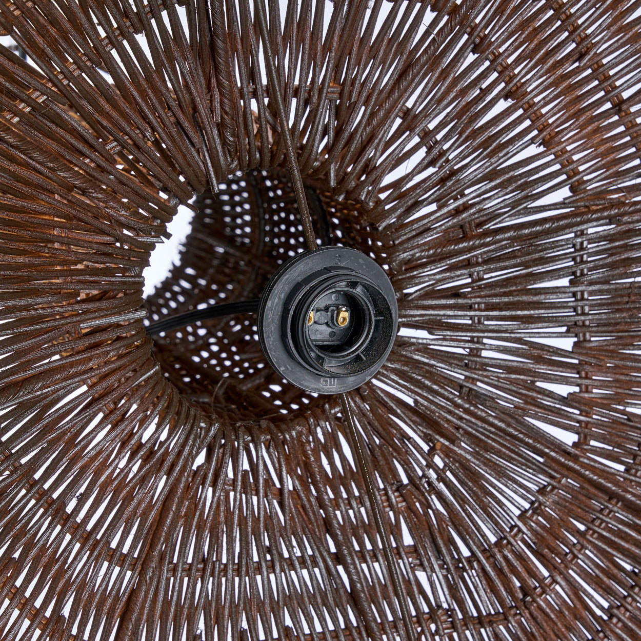 Close-up of a wicker pendant with a detailed pattern