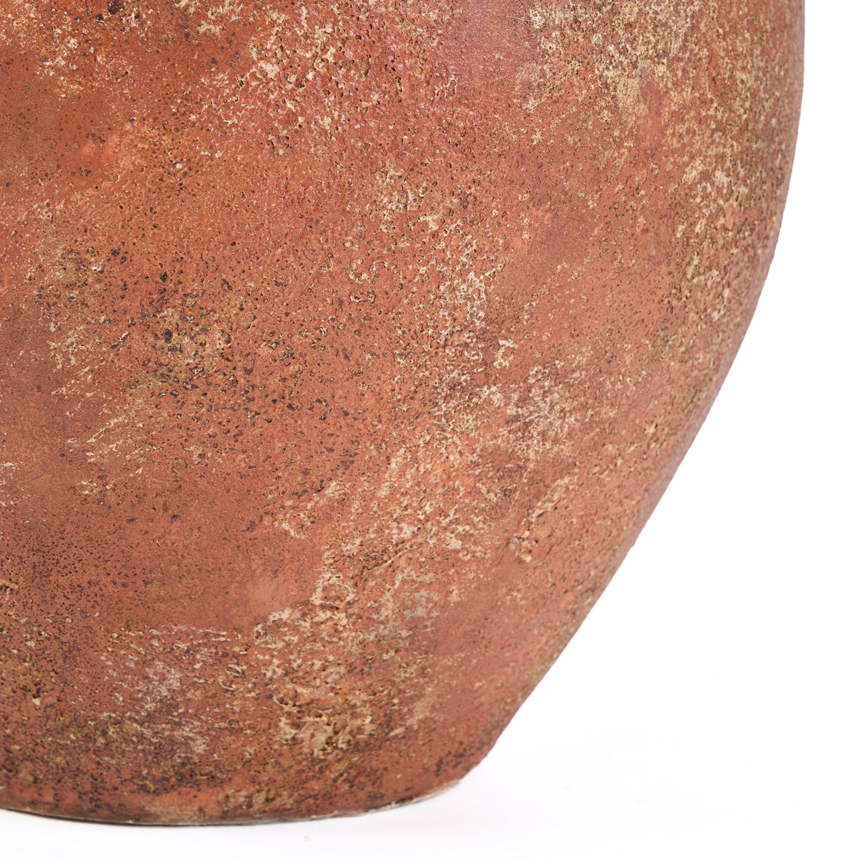 Close-up of a terracotta pot with a textured surface on a white background