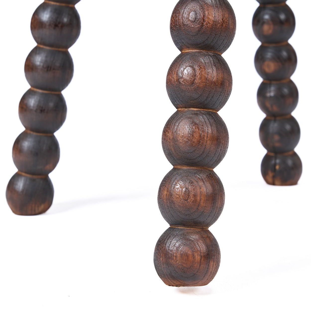 Wooden beaded legs of stool on a white background