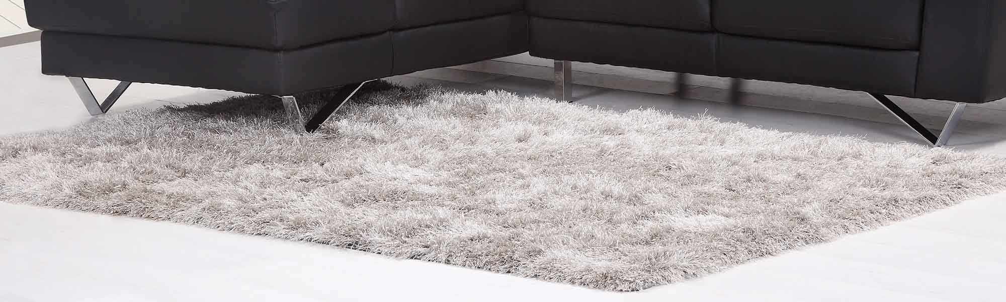 A soft fluffy rug of cream colour near the sofa
