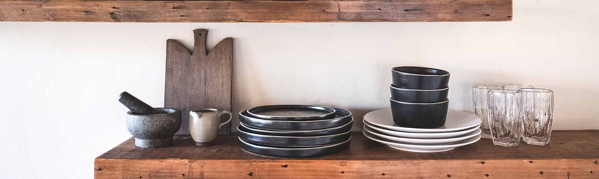 Craft ceramic dinnerware on a wooden shelf