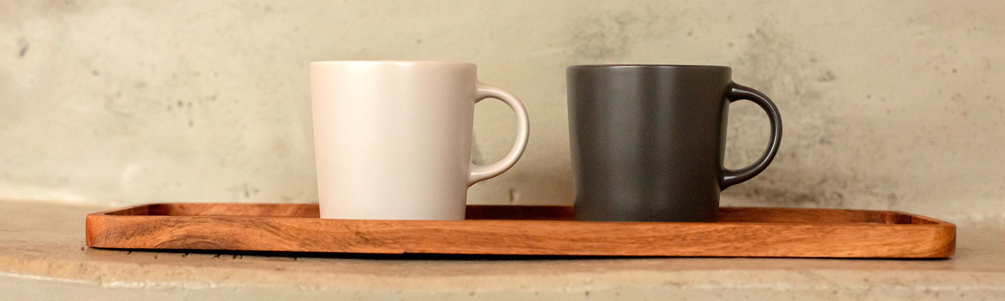 Cream and black mug on a wooden shelf