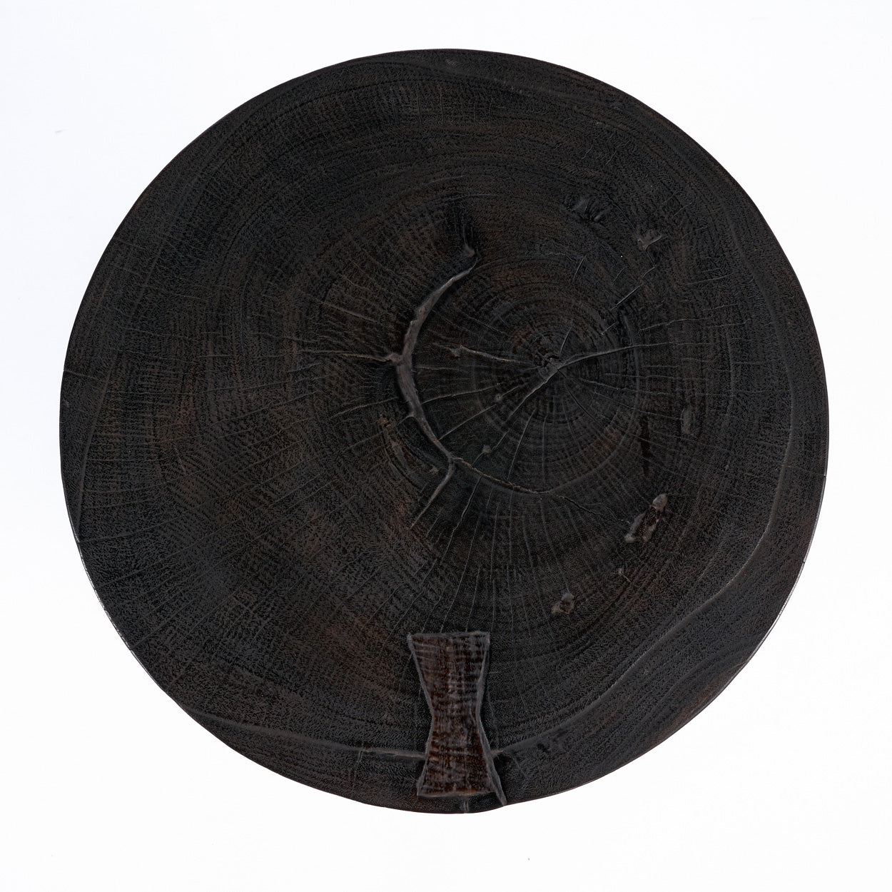 Dark round top of side table on a white background