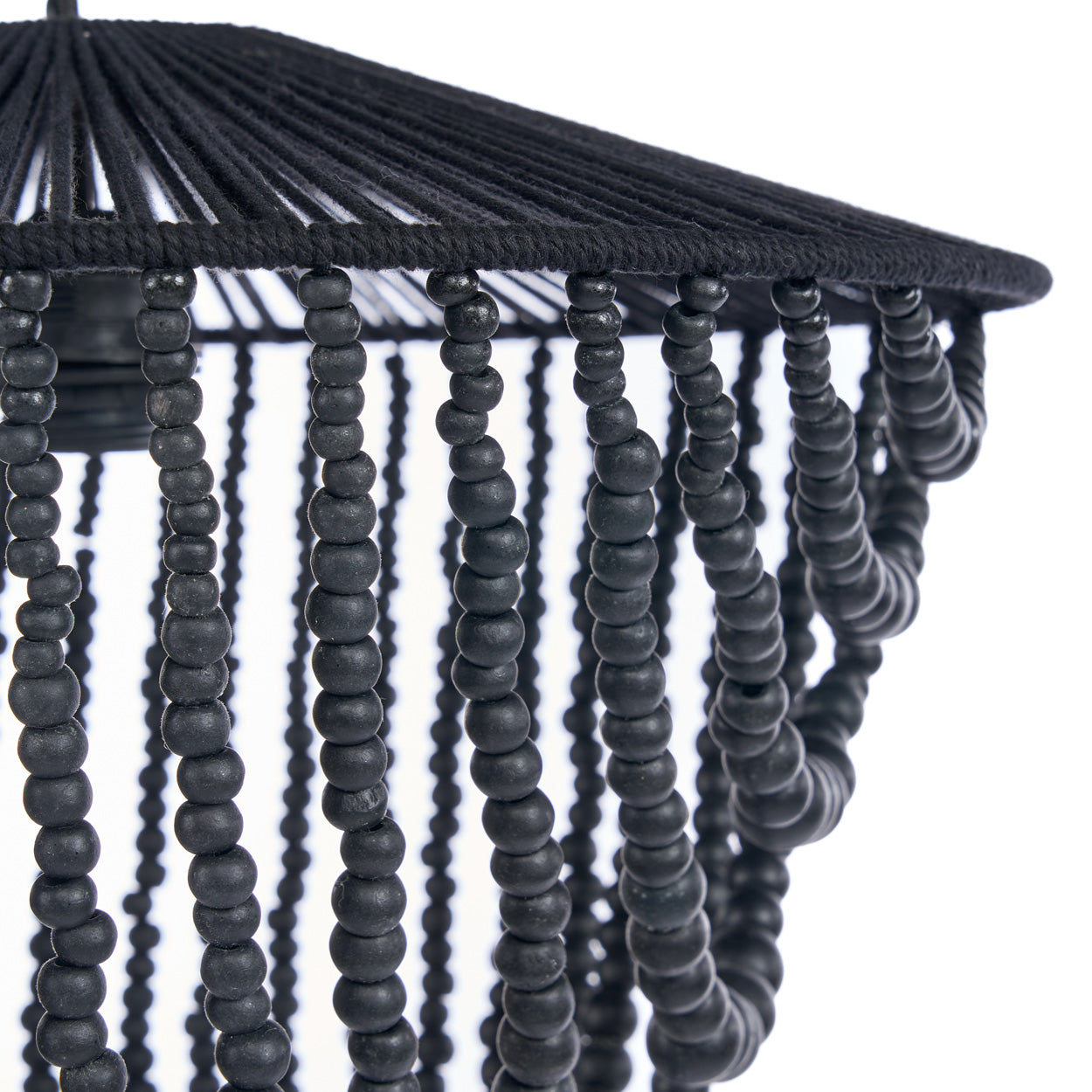 Close-up of a black beaded lampshade with a white background
