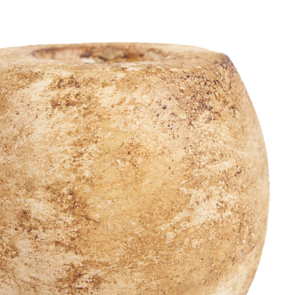 Close-up of a textured beige cande holder on a white background