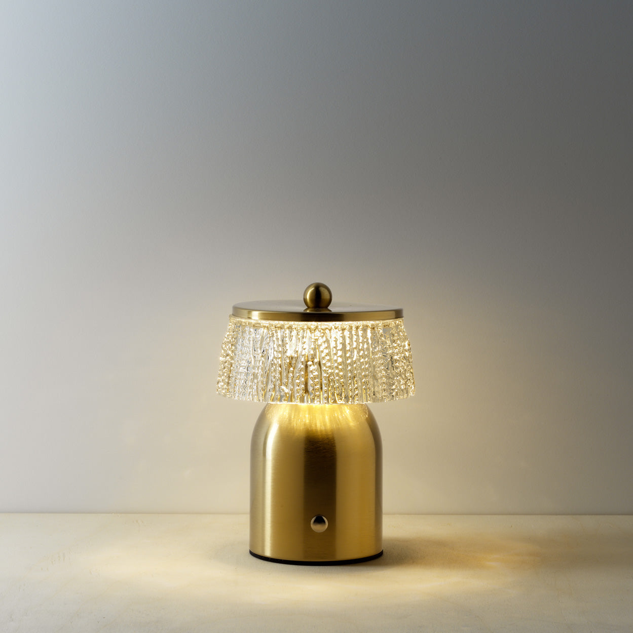 Gold table lamp with crystal detailing on a warm background