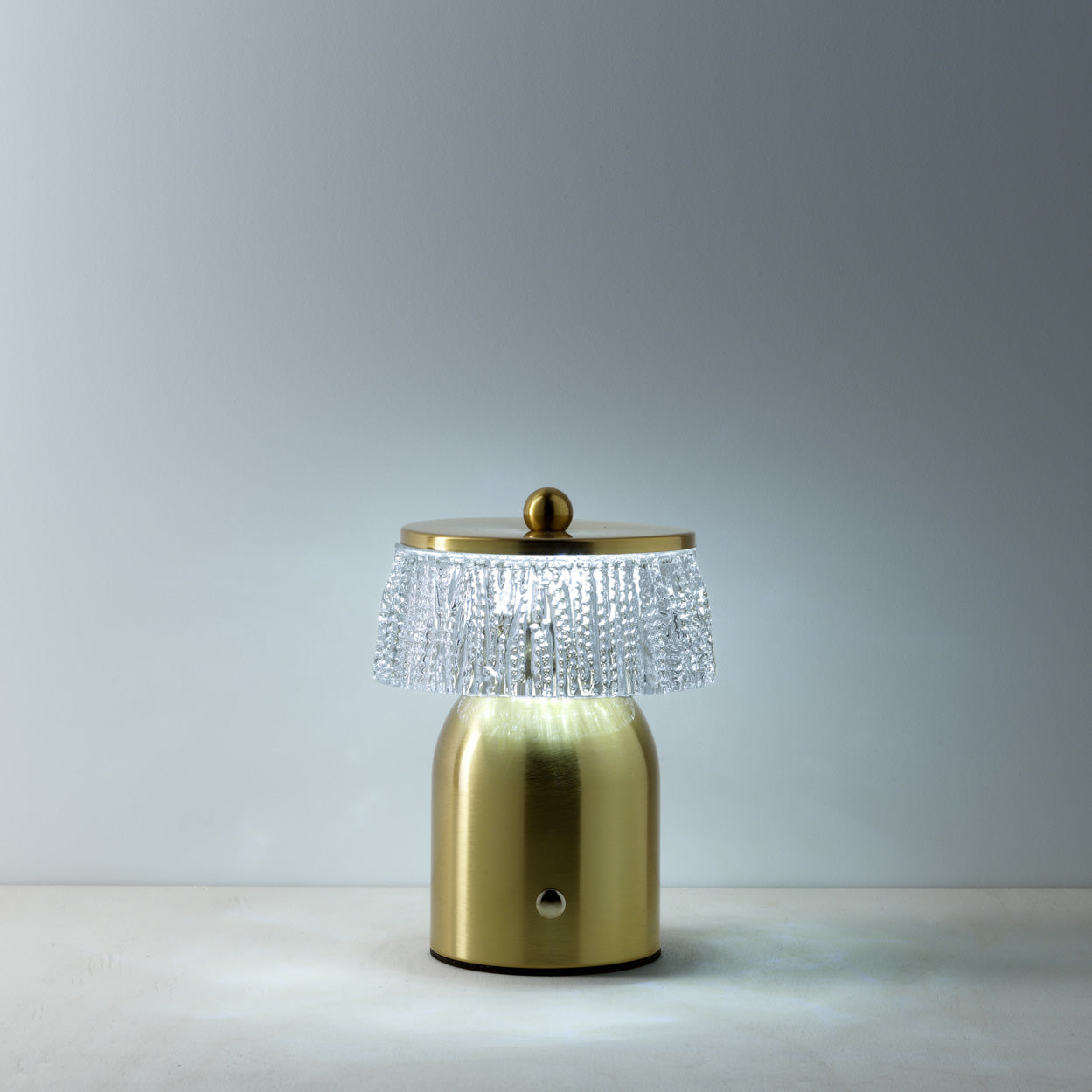Gold table lamp with crystal detailing on a neutral background