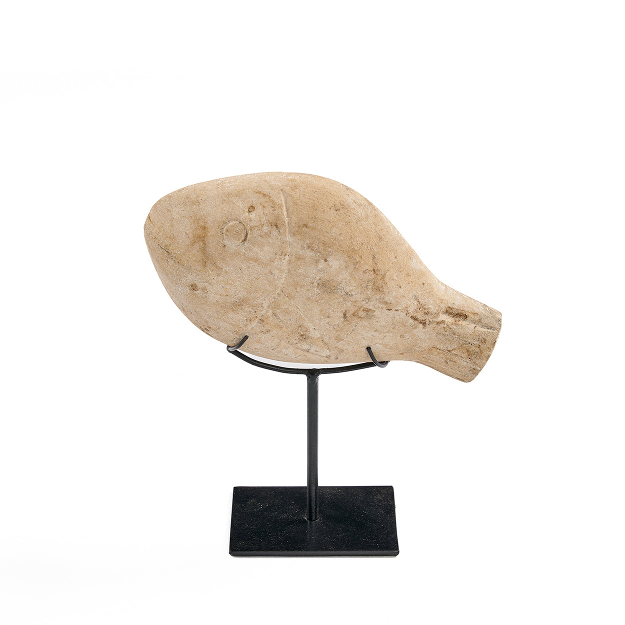 Decorative stone fish on a black stand against a white background
