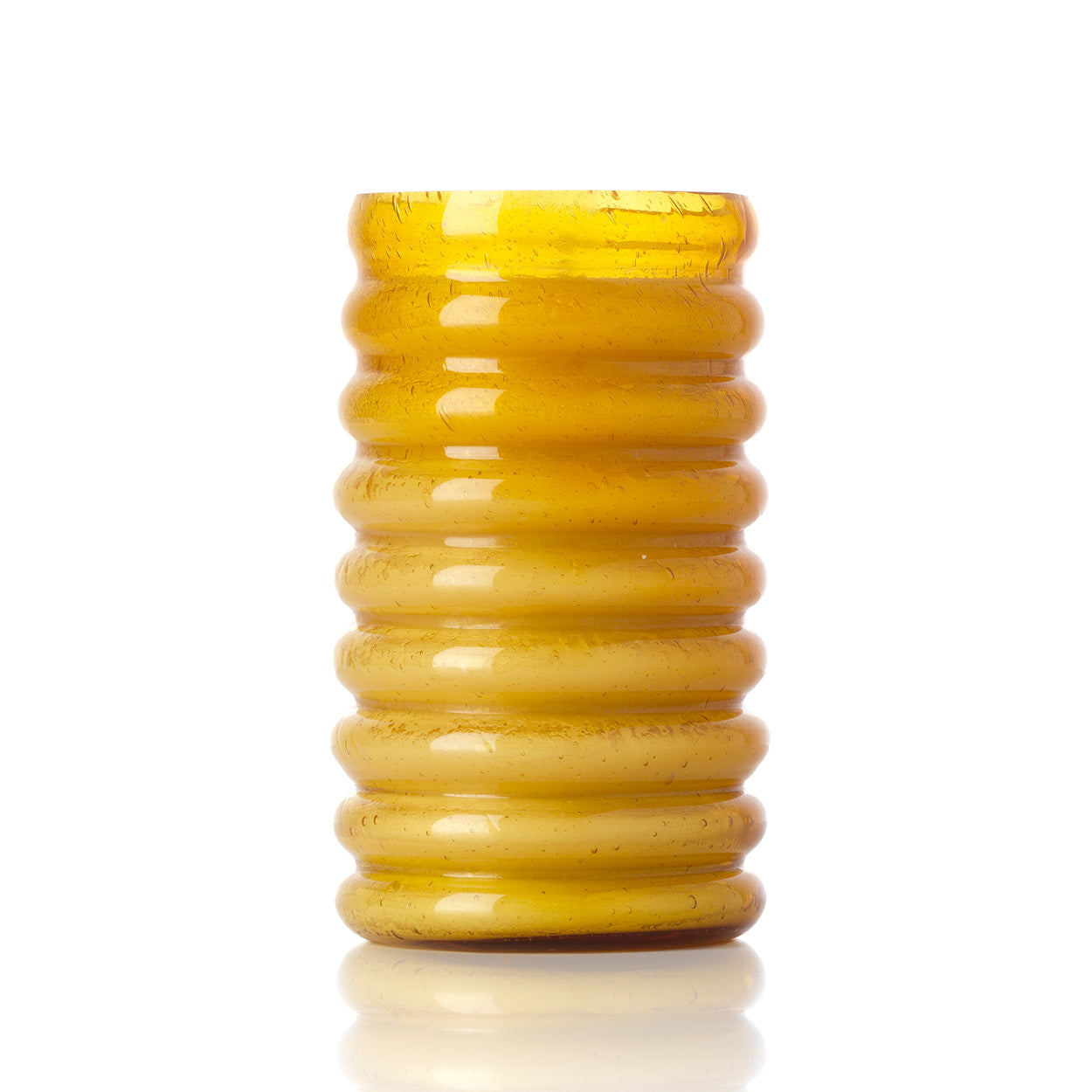 Tall yellow glass candle holder on a white background