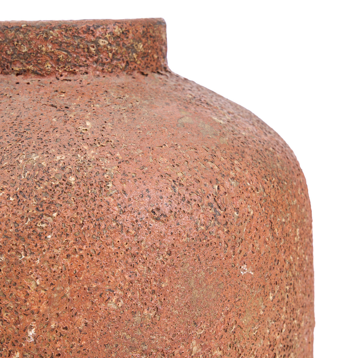 Close-up of a textured terracotta vase on a white background