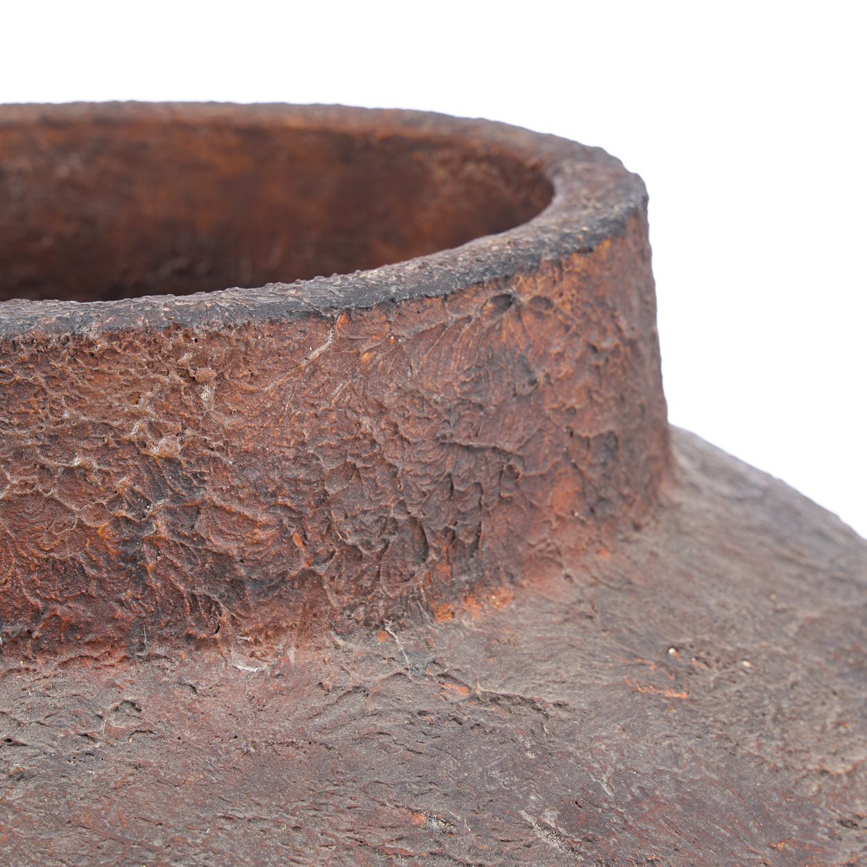 Close-up of a rusted vase on a white background