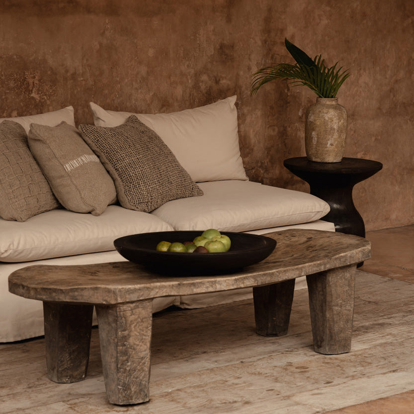 Cozy living room with a beige sofa, wooden coffee table, and side table