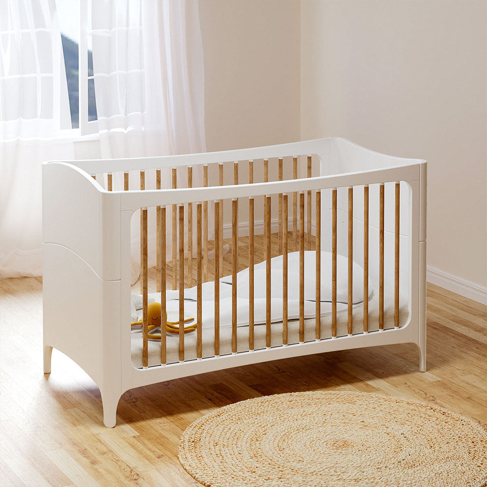 NEREE LIT Bed 70X140 - Neige with wooden slats on a wooden floor in a bright room.