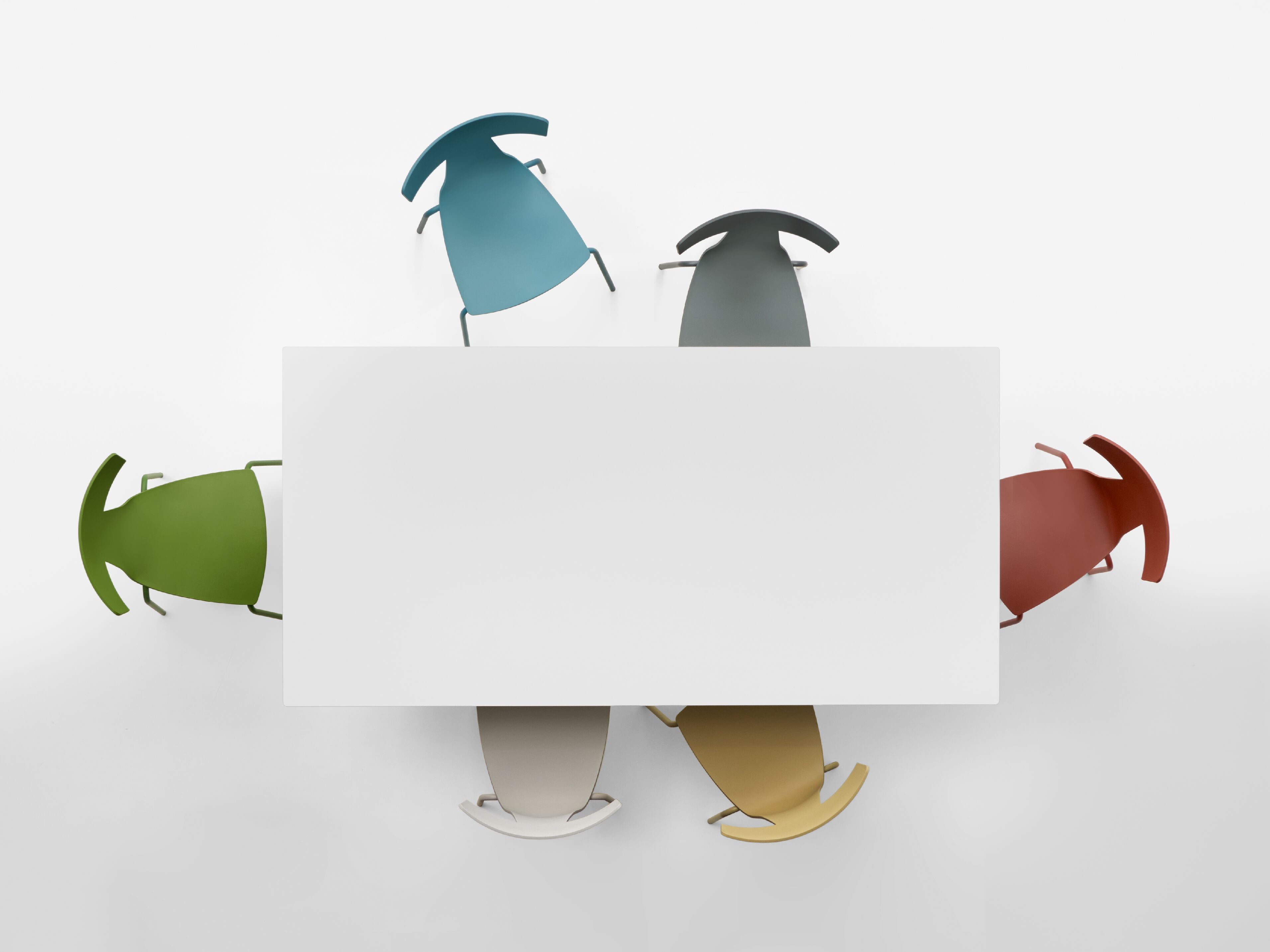 A minimalist studio rendering of five modern chairs in different colors (green, teal, dark gray, rust red, and beige) arranged around a white MART rectangular table on a light gray background.