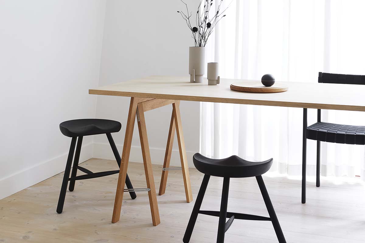 Nordic design wooden dining table with black chairs